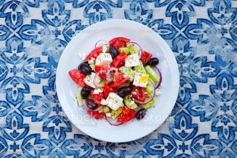 Greek salad. Fresh vegetables, feta cheese and black olives. Top view.